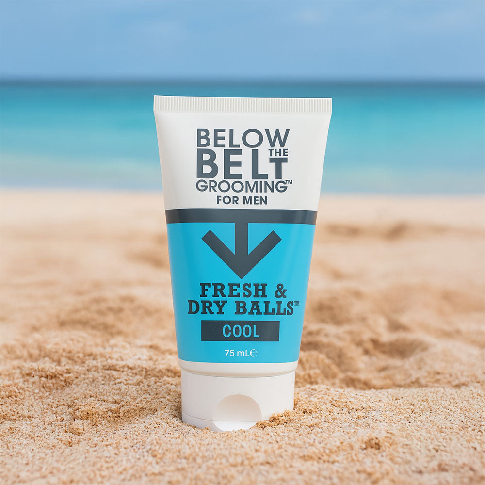 Tube of intimate deodorant on a sandy beach.